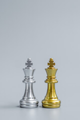 Gold and silver Chess King figure on Chessboard against opponent or enemy. Strategy, Conflict, management, business planning, tactic, politic, communication and leader concept © Jo Panuwat D