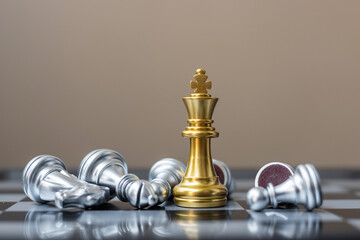 gold Chess king figure stand out from crowd of enermy or opponent during chessboard competition....