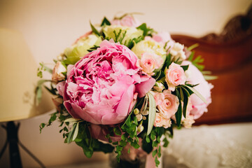 Wedding bouquet of a bride with pink roses and peonies