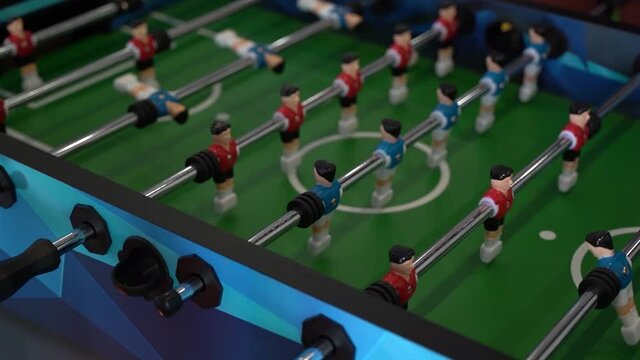 Foosball. Hands of a man playing table football