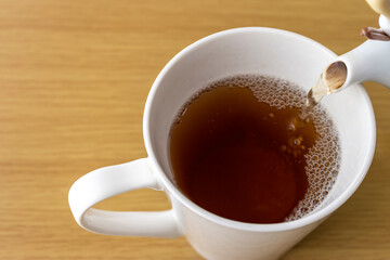 カップに紅茶を入れるイメージ