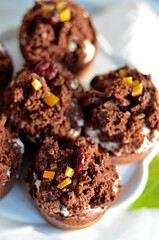 Chocolate muffins with cream on a white plate