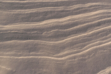 Compressed layers of snow for the backdrop. Smooth contour lines of the layer. Shine.