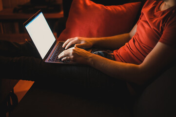 Portrait of attractive nerdy man is working late night on the computer in living room in home office
