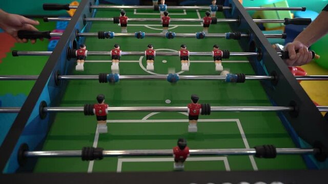 Foosball. Hands of a man playing table football