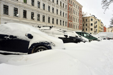 Snow covered cars parking on a street in Leipzig, Germany