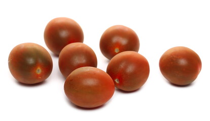 Mini kumato tomato pile isolated on white background