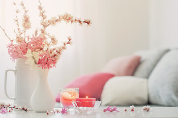 spring pink flowers in vase on white interior