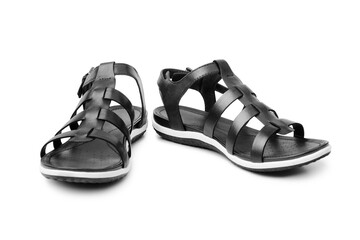 Black female sandals on white background isolated closeup front view, stylish woman sandal shoes with straps, pair of fashion leather summer sandals, two boots, casual walking footwear, urban footgear