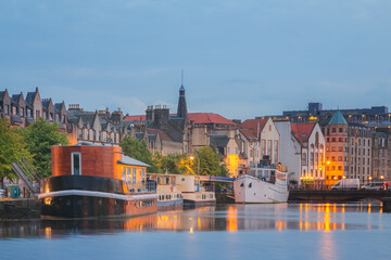 A scenic cityscape at night of the Leith Shore, a port area in the north of Edinburgh, Scotland.