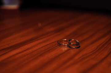 Wedding gold rings on brown background