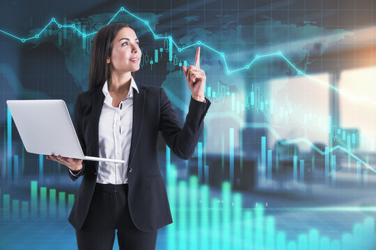 Businesswoman with laptop shows finger up found a solution and digital screen behind her with glowing financial chart with graphs and diagram. Double exposure.