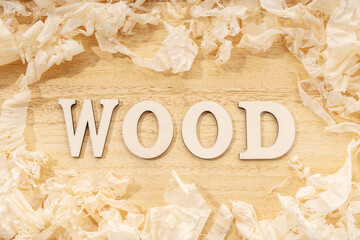Wooden word or wood table ans wood shavings. Woodworking, craftsmanship and handwork concept, flat...