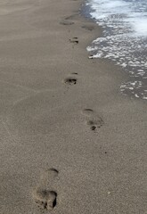 Footprints of bare feet on the sand of the seashore. Patara Beach