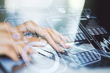 Multi exposure of creative statistics data hologram with hands typing on computer keyboard on background, stats and analytics concept