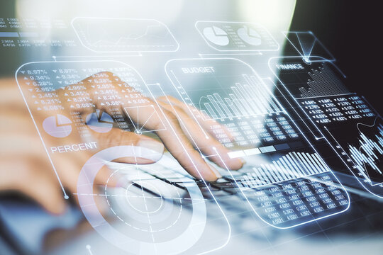 Multi exposure of creative statistics data hologram with hands typing on computer keyboard on background, stats and analytics concept