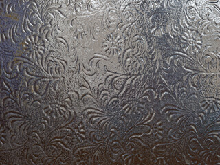 Dark glass texture with patterns, glass texture behind which there is light