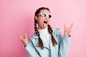 Photo of young brutal girl tongue-out show fingers rock sign music lover isolated over pastel color...