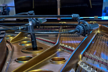 the grand piano stands on the stage of the concert hall
