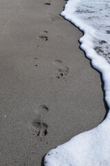 Footprints of bare feet on the sand of the seashore. Patara Beach