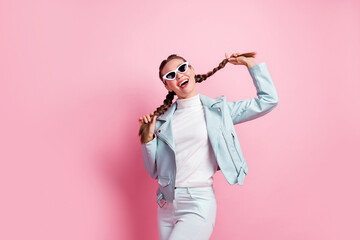 Photo of young excited girl happy positive smile childish playful look empty space isolated over pink color background