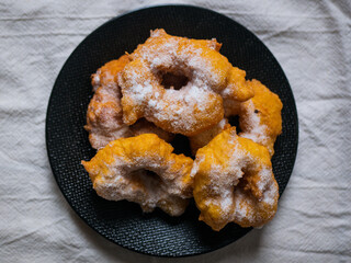 Woman frying vegan cattas sweet fritters, Sardinian Carnival cakes
