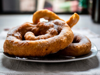 Woman frying vegan cattas sweet fritters, Sardinian Carnival cakes