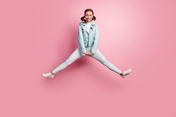 Fototapeta na wymiar Full length photo portrait of excited woman jumping up isolated on pastel pink colored background