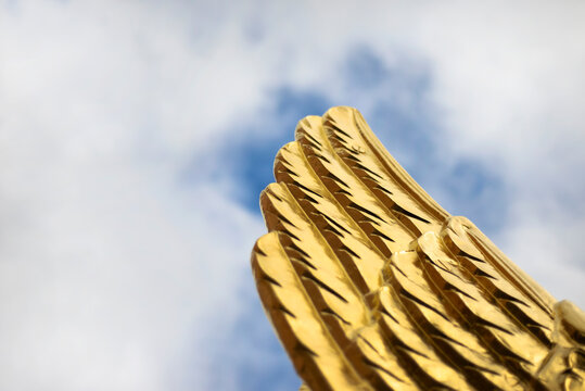 Hollow wing against the sky with clouds.