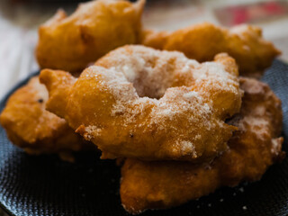 Woman frying vegan cattas sweet fritters, Sardinian Carnival cakes