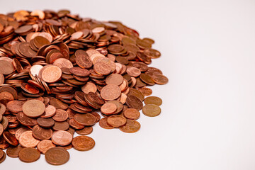 Many small euro coins on each other on white background