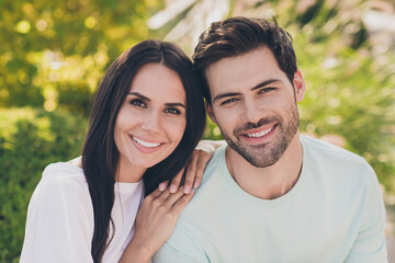 Fototapeta premium Photo of two romantic people sit grass girlfriend touch boyfriend shoulder wear casual clothes in garden park outdoors