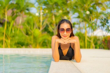 Portrait beautiful young asian woman relax smile enjoy leisure around swimming pool