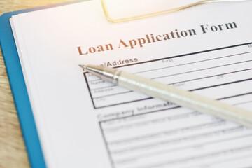 Loan application form, Financial loan money contract agreement company credit or person with a pen filling in information.