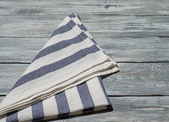 Wooden background with linen kitchen towel or textile napkin.