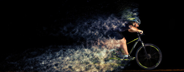 Man racing cyclist in motion . Cyclist in studio with creative effects. Scattering effect. Creative...