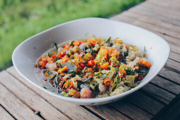 Sambal Matah. Traditional raw chili and lemongrass relish from Bali. Plated on a white bowl.