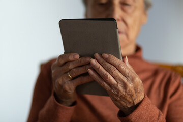 Senior woman using an e book. Selective focus.