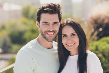 Fototapeta premium Photo of two cheerful people together toothy beaming smile look camera cuddle wear casual clothes street outdoors