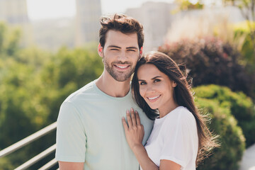 Photo of tempting young couple boyfriend girlfriend cuddle hand chest look camera wear casual...