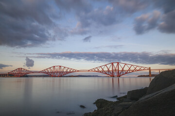 Sunset or sunrise view of the 19th century and Unesco heritage site Forth Rail Bridge over the Firth of Forth at the Queensferry Crossing north of Edinburgh, Scotland