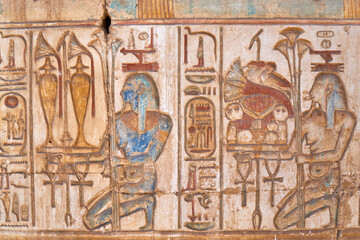 Two kneeling Nile Gods presenting the abundence, provided by the river - wall relief from Abydos