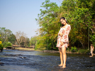 A woman wearing red dress playing in the water at Coffee shop called 