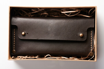 Brown leather purse in box