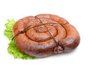 Smoked sausage twisted in a spiral and bound with a beechnut, isolated on a white background.