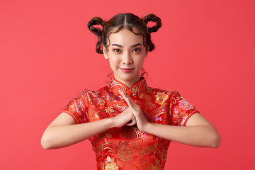 Asian chinese woman in traditional dress on red background. Chinese new year festival.