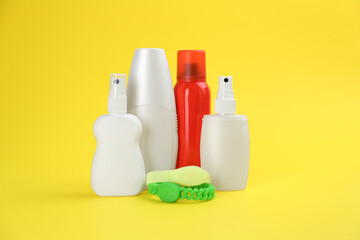 Set of different insect repellents on yellow background