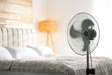 Fototapeta Modern electric fan in bedroom. Space for text obraz
