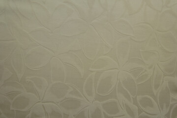 Top view of glossy cream colored polyamide fabric with floral pattern