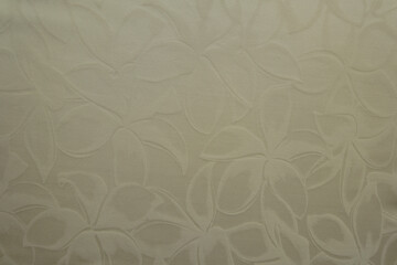 Fototapeta premium Top view of glossy cream colored polyamide fabric with floral pattern